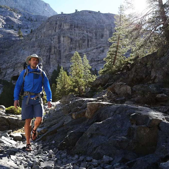 A man hiking through the mountains wearing Shamma Mountain Goats.