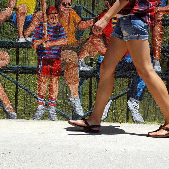 Shamma Old Goats leather sandals woman walking with mural