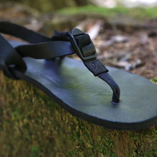 Shamma All Blacks sandal on mossy rock
