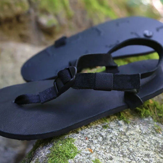 All Blacks sandals on moss rocks
