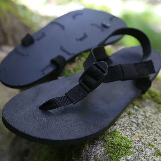 Shamma All Blacks sandals on mossy rocks