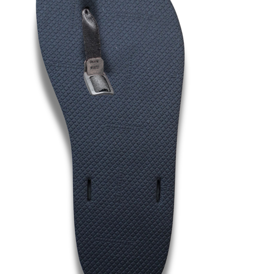 Black textured sandal sole with toe strap and buckle installed