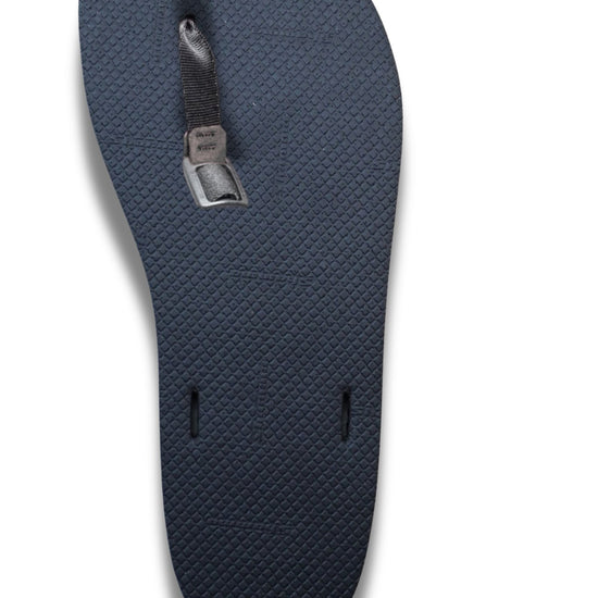 Black textured sandal sole with toe strap and buckle installed