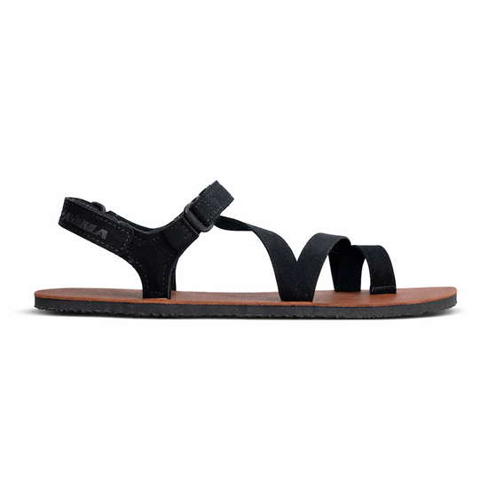 Black sandal with a brown sole on a white background
