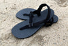 Black Chargers sandals on sand