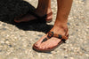 Shamma Old Goats leather sandals woman&#39;s feet on cobblestone