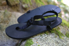 All Blacks sandals on moss rocks