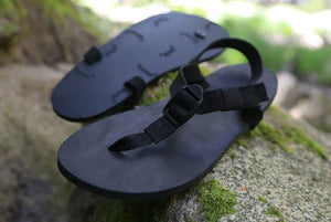 Shamma All Blacks sandals on mossy rocks