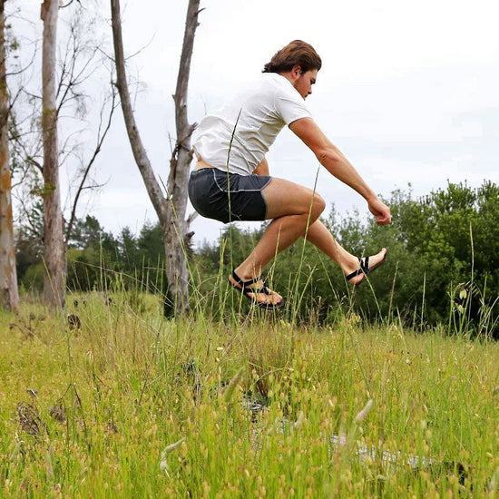 huaraches running sandals leaping in the air over grass