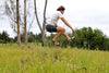 huaraches running sandals leaping in the air over grass