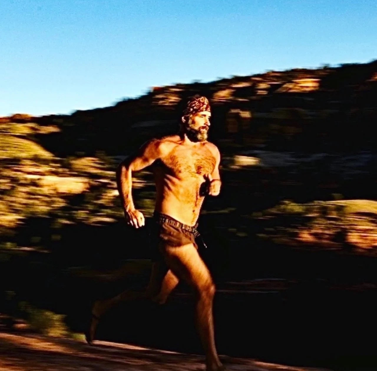 Matt Graham running a desert trail at sunset